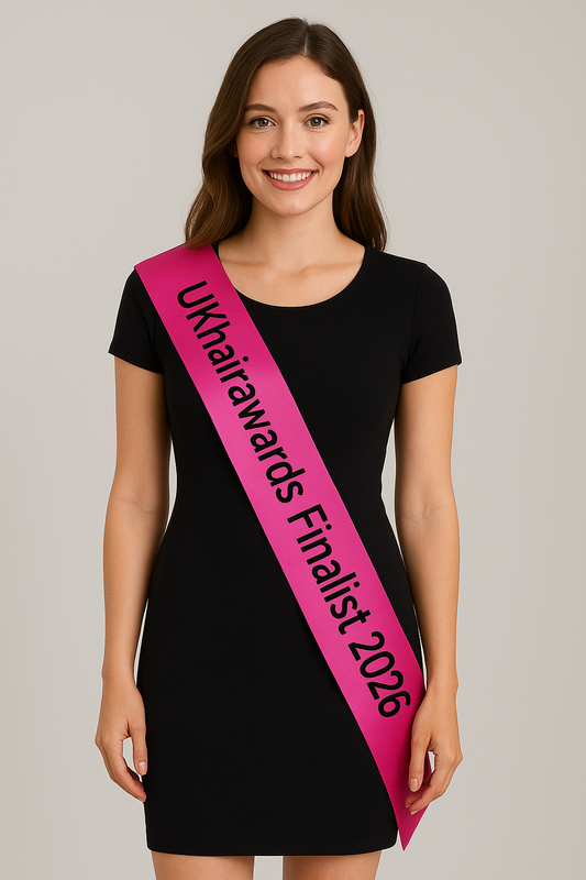 Woman wearing hot pink UKhairawards Finalist 2026 Satin Sash with black lettering